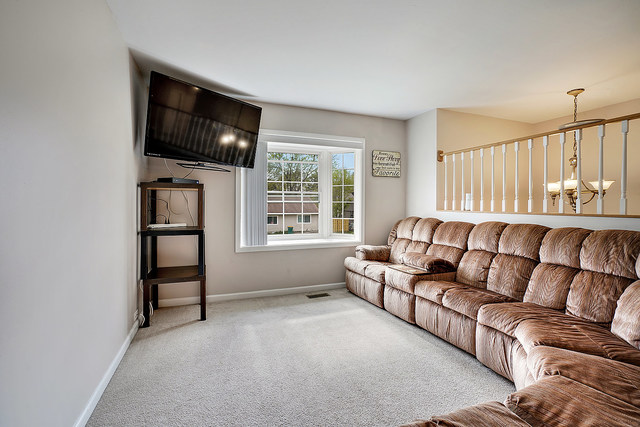 727 Delta Avenue Romeoville, IL 60446 - Photo 3 of 11 a living room with furniture and a flat screen tv