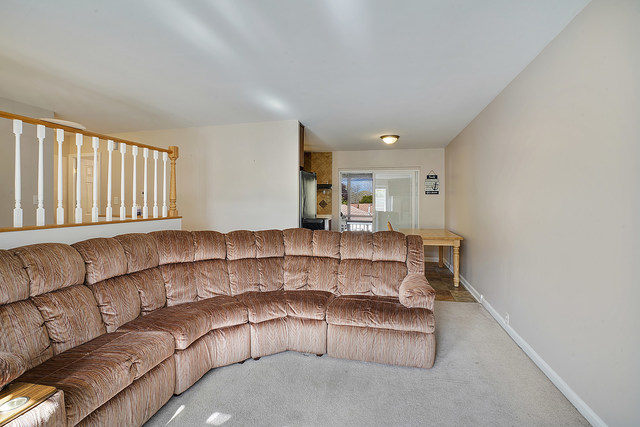727 Delta Avenue Romeoville, IL 60446 - Photo 4 of 11 a living room with a couch and a dresser with wooden floor
