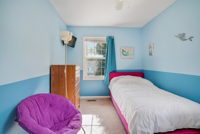 727 Delta Avenue Romeoville, IL 60446 - Photo 7 of 11 a bed room with a bed and a chair