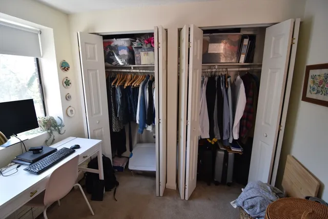 a view of a workspace with furniture and a flat tv screen