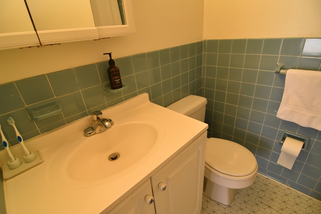 24 Highland Avenue, Unit 5 Cambridge, MA 02139 - Photo 7 of 9 a bathroom with a sink a toilet and a mirror