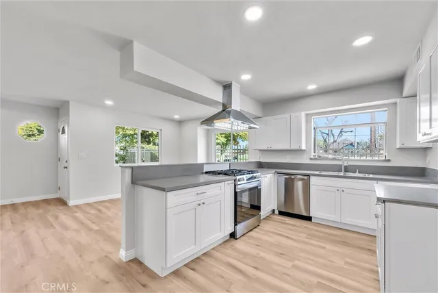 a kitchen with granite countertop a sink and cabinets
