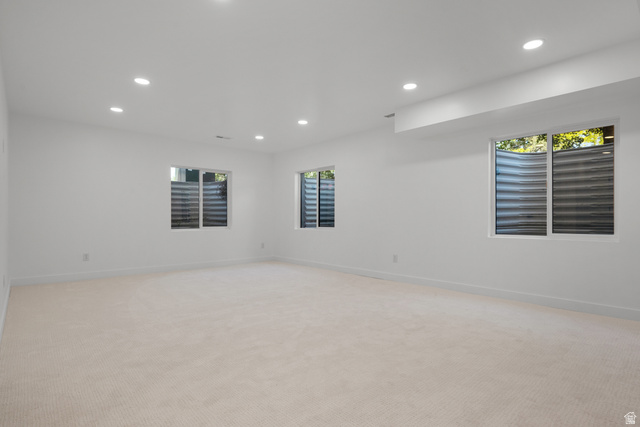 7238 South 525 East Midvale, UT 84047 - Photo 22 of 29 Spacious room featuring light-colored carpeting, multiple recessed lighting fixtures, and three large windows
