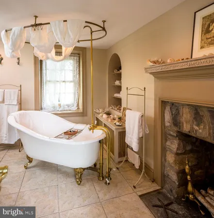 a spacious bathroom with a tub sink and mirror