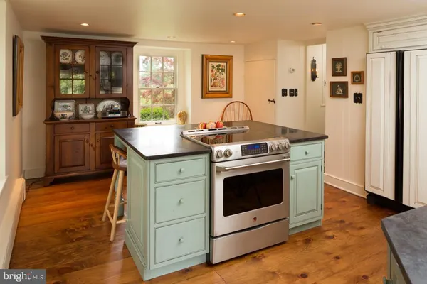 a kitchen with stainless steel appliances granite countertop a stove and a sink