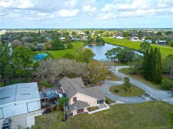 an aerial view of a house with garden space and lake view