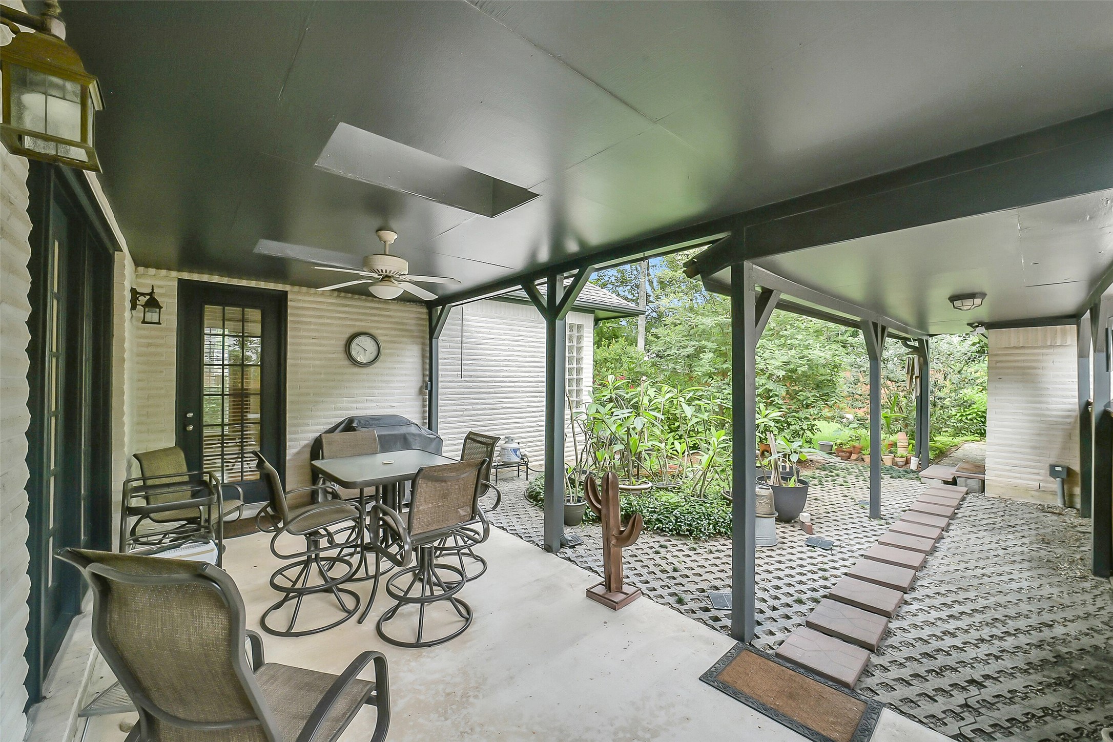 1260 Fries Road Houston, TX 77055 - Photo 35 of 42 Beautiful Covered Patio with fresh Paint and Pavers with Ceiling Fan and beams Facing East so Plenty of Afternoon and Evening Shade!