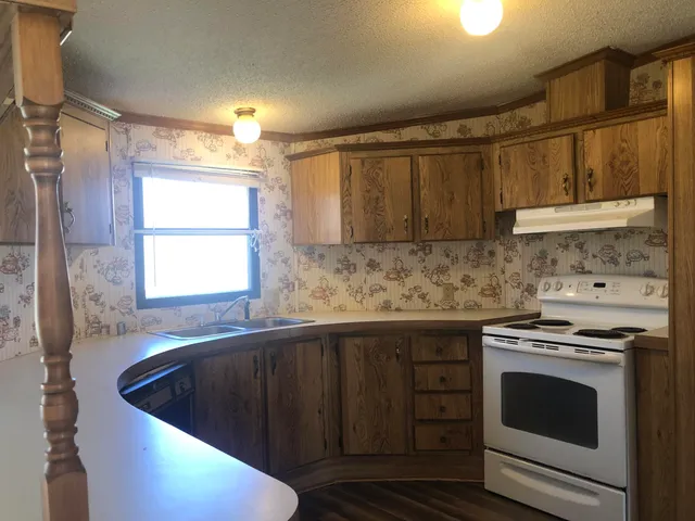a kitchen with sink cabinets and window
