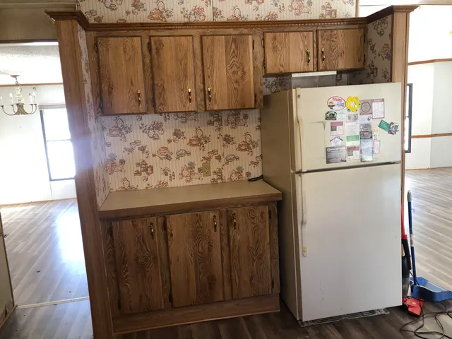 a white refrigerator freezer sitting inside of a kitchen