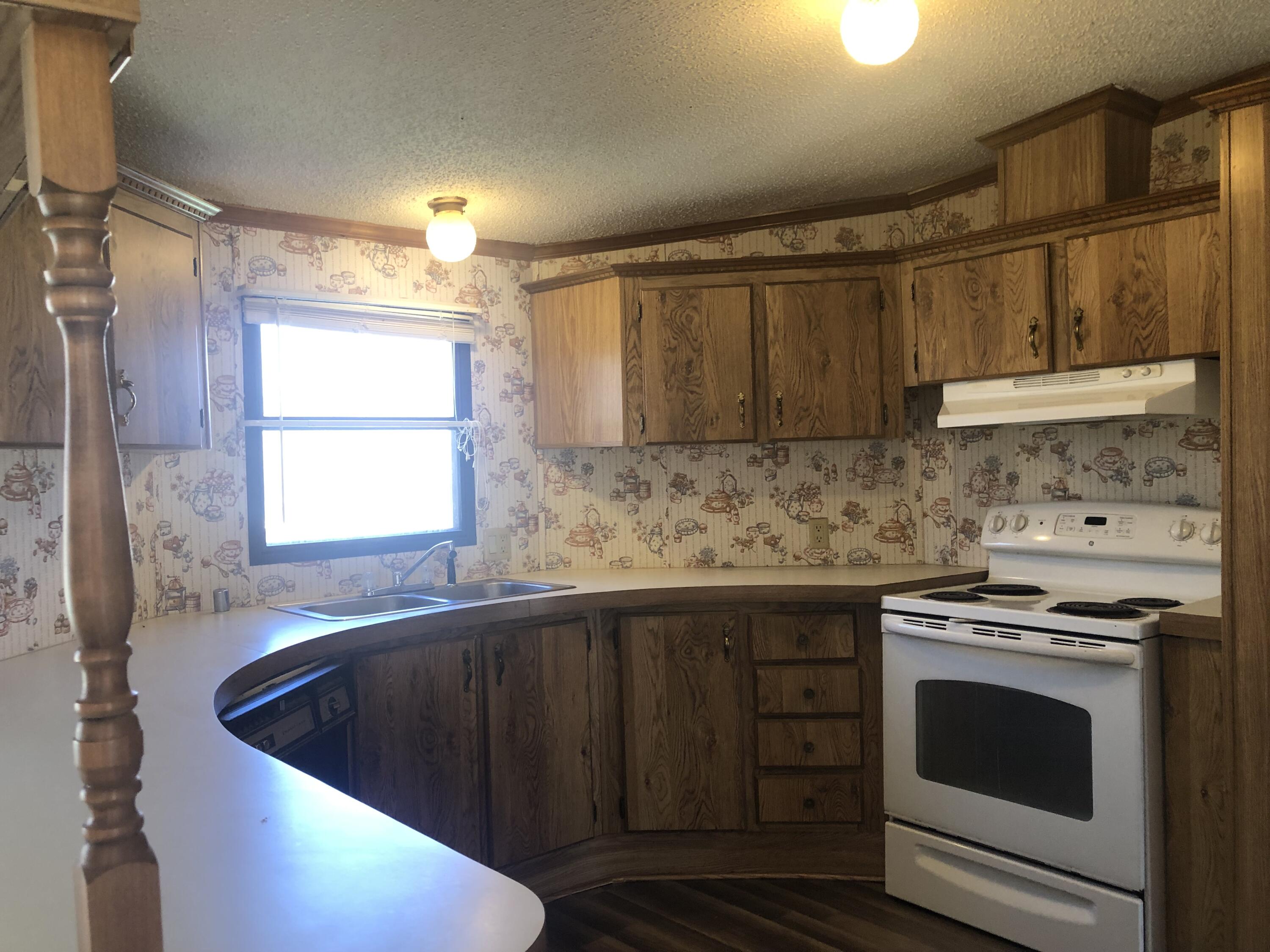 9210 Potts Creek Road Covington, VA 24426 - Photo 14 of 32 a kitchen with sink cabinets and window
