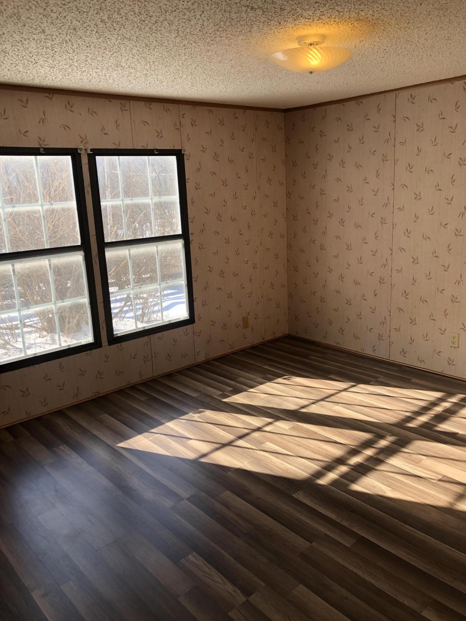 9210 Potts Creek Road Covington, VA 24426 - Photo 16 of 28 a view of empty room with wooden floor and fan