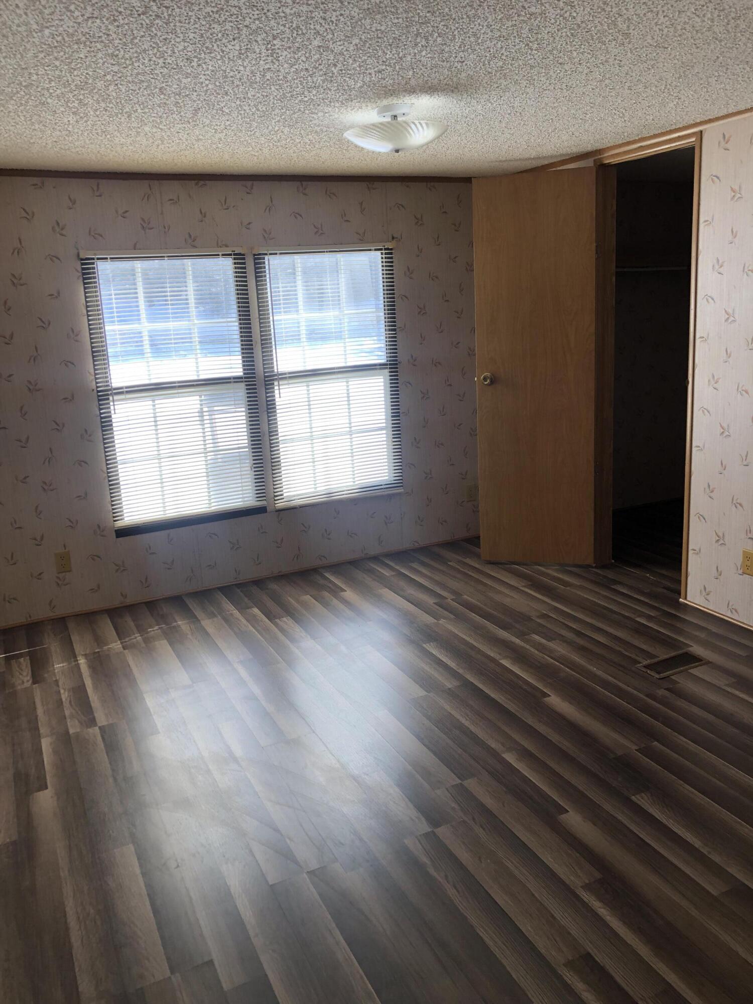 9210 Potts Creek Road Covington, VA 24426 - Photo 18 of 32 an empty room with wooden floor and windows