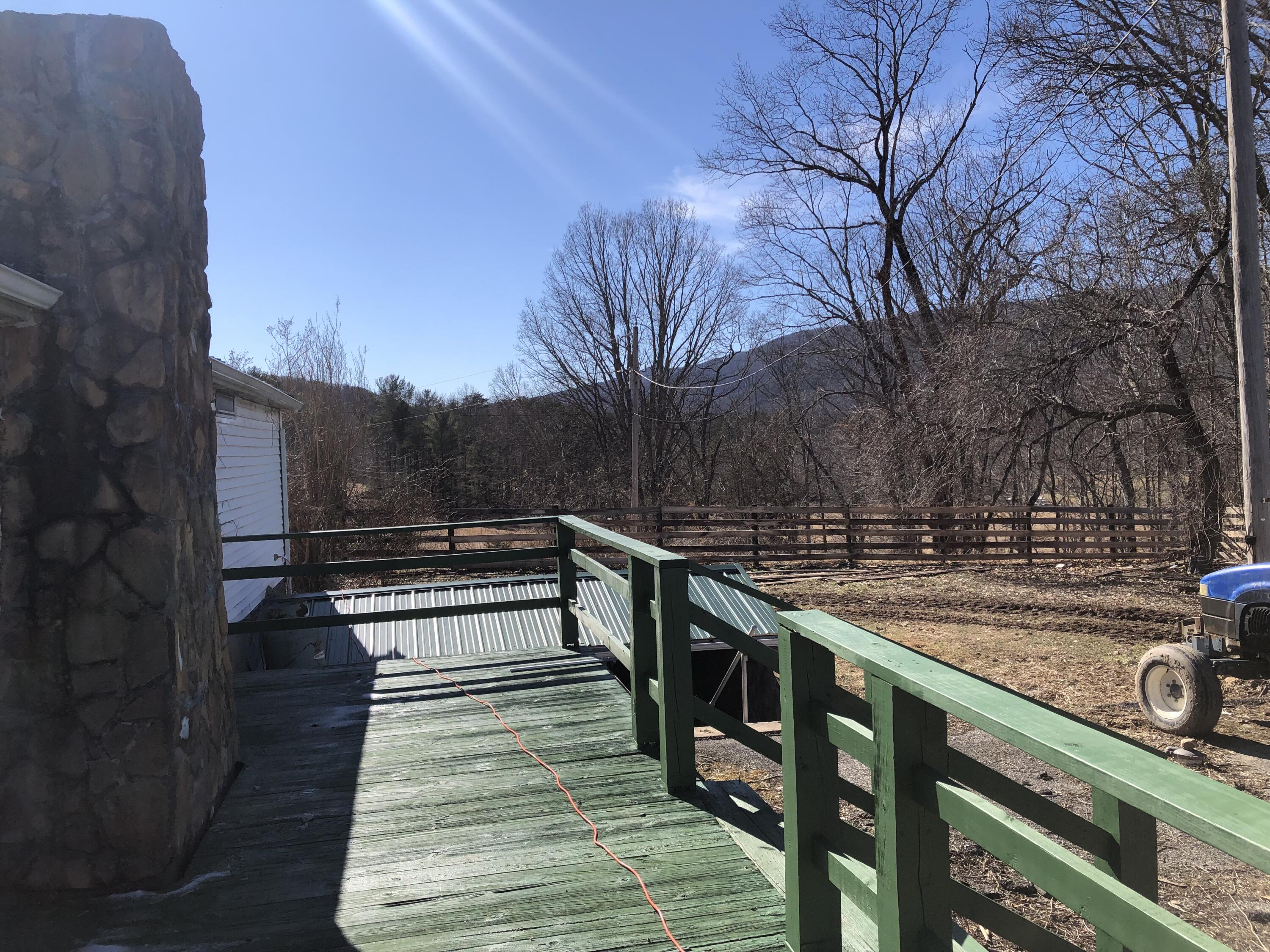 9210 Potts Creek Road Covington, VA 24426 - Photo 4 of 28 a view of a balcony with wooden floor and trees