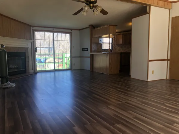 a view of a kitchen with a stove wooden floor and a kitchen space
