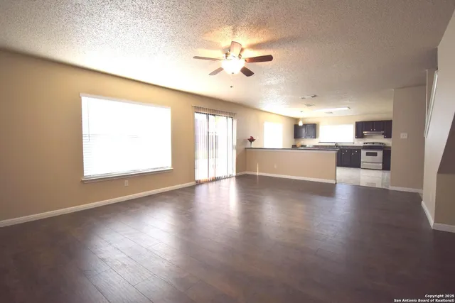 a view of a kitchen with a stove wooden floor and a kitchen