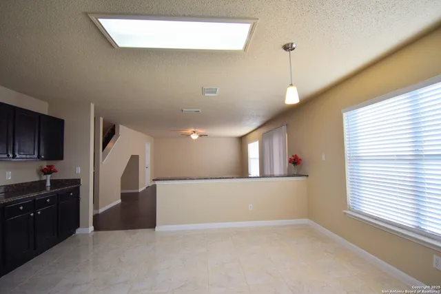 a view of a kitchen with a sink and a window