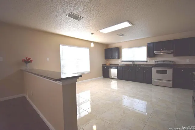 a large kitchen with cabinets and stainless steel appliances