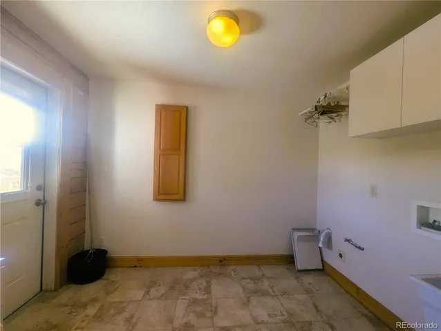 a view of a room with wooden floor and windows