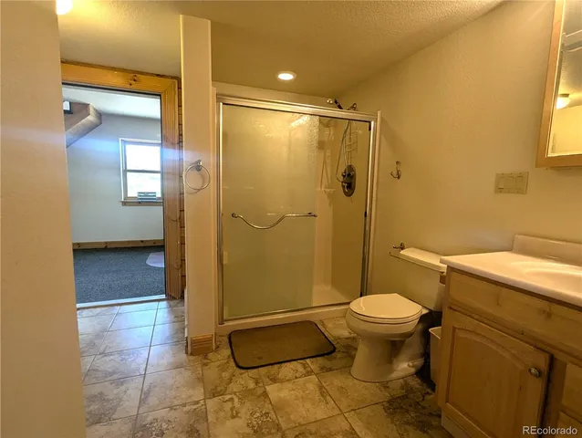 a bathroom with a toilet and a shower