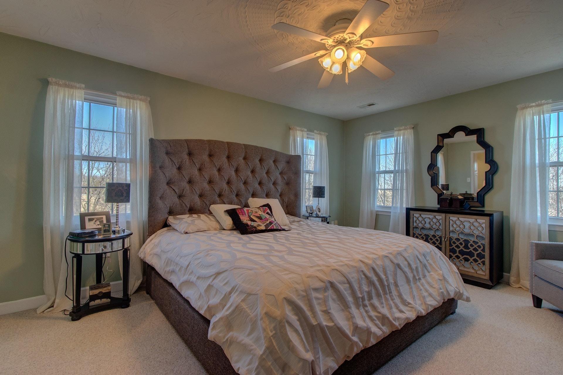 600 Dugwell Road Boones Mill, VA 24065 - Photo 13 of 78 a bedroom with a bed and a chandelier
