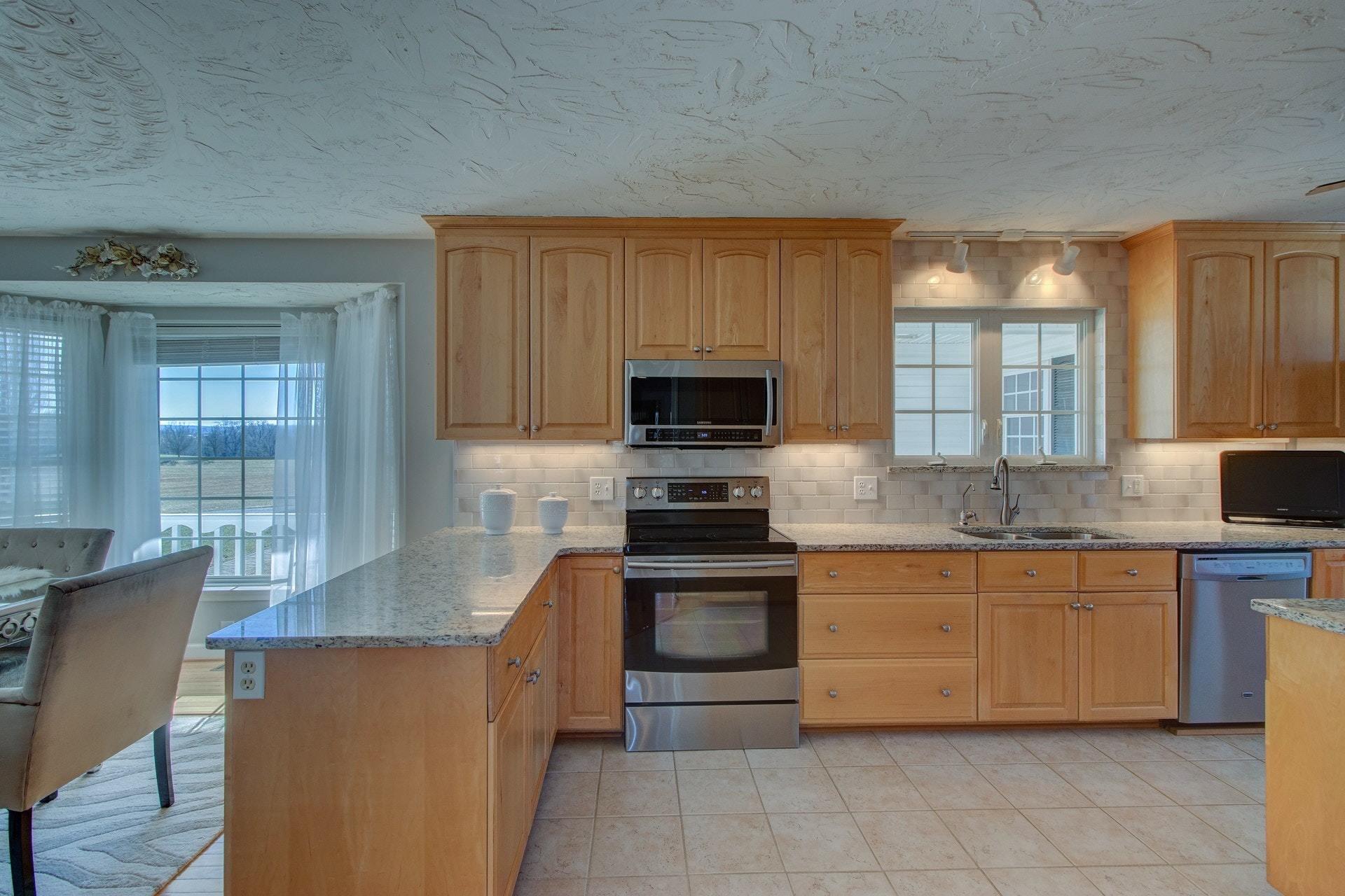 600 Dugwell Road Boones Mill, VA 24065 - Photo 35 of 78 a kitchen with stainless steel appliances granite countertop a stove sink and microwave