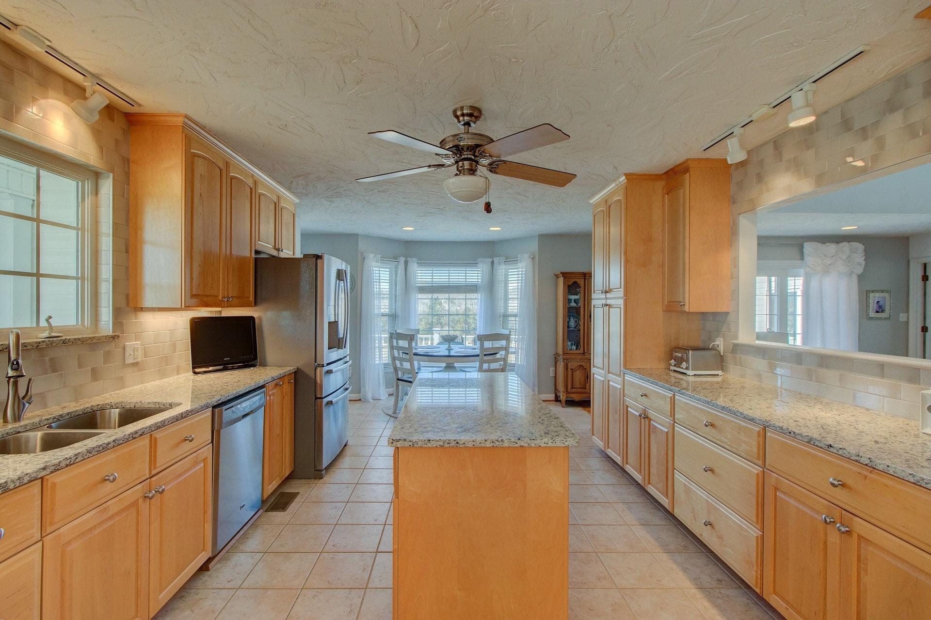 600 Dugwell Road Boones Mill, VA 24065 - Photo 36 of 78 a large kitchen with kitchen island granite countertop a sink and refrigerator