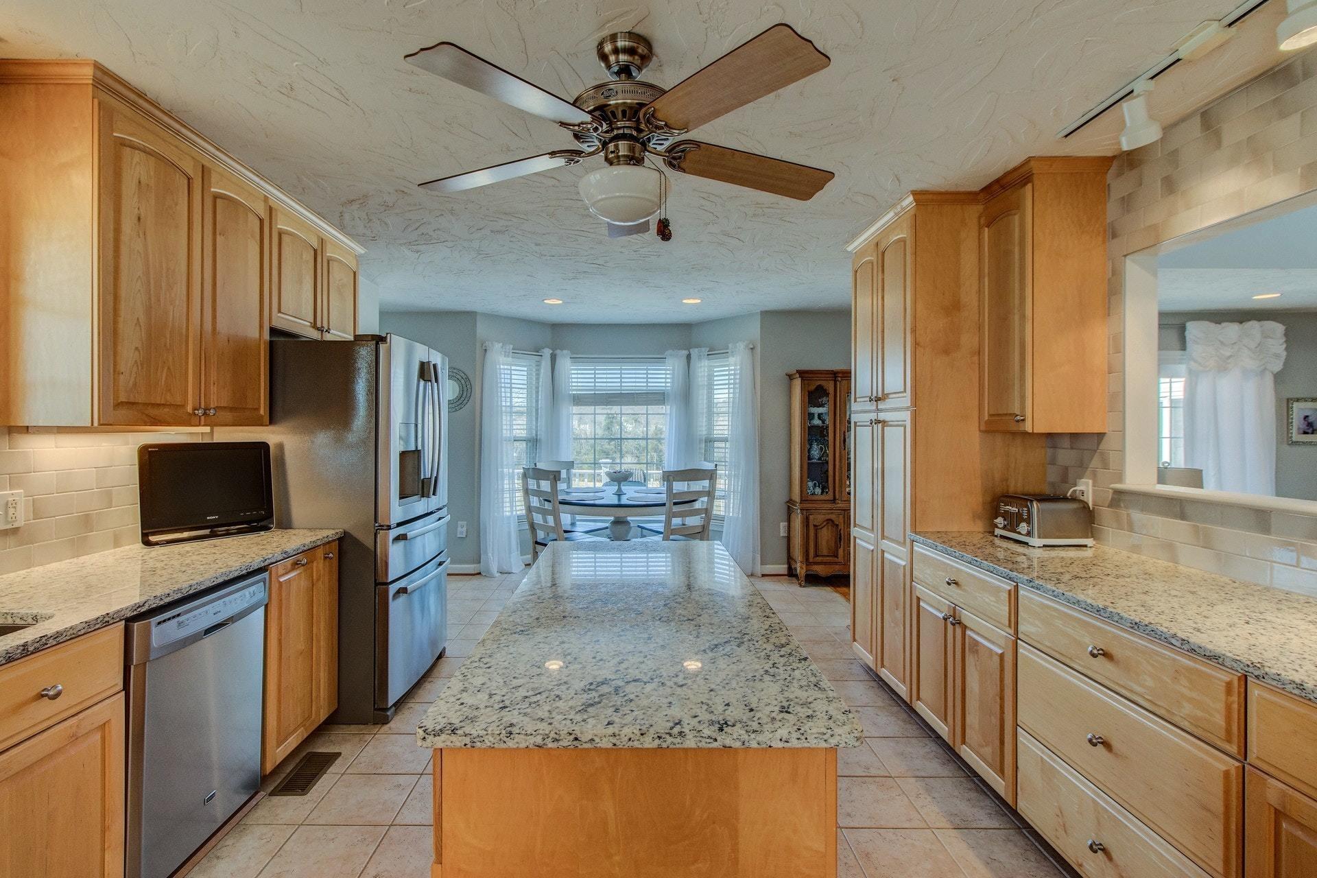 600 Dugwell Road Boones Mill, VA 24065 - Photo 37 of 78 a kitchen with stainless steel appliances granite countertop a sink stove and refrigerator