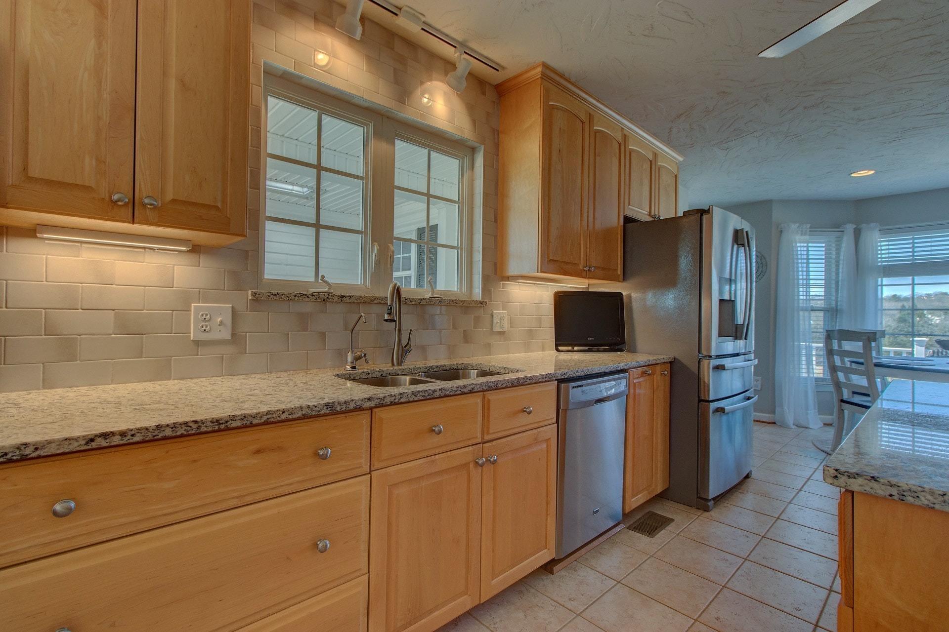 600 Dugwell Road Boones Mill, VA 24065 - Photo 38 of 78 a kitchen with granite countertop cabinets stainless steel appliances a sink and a counter top space