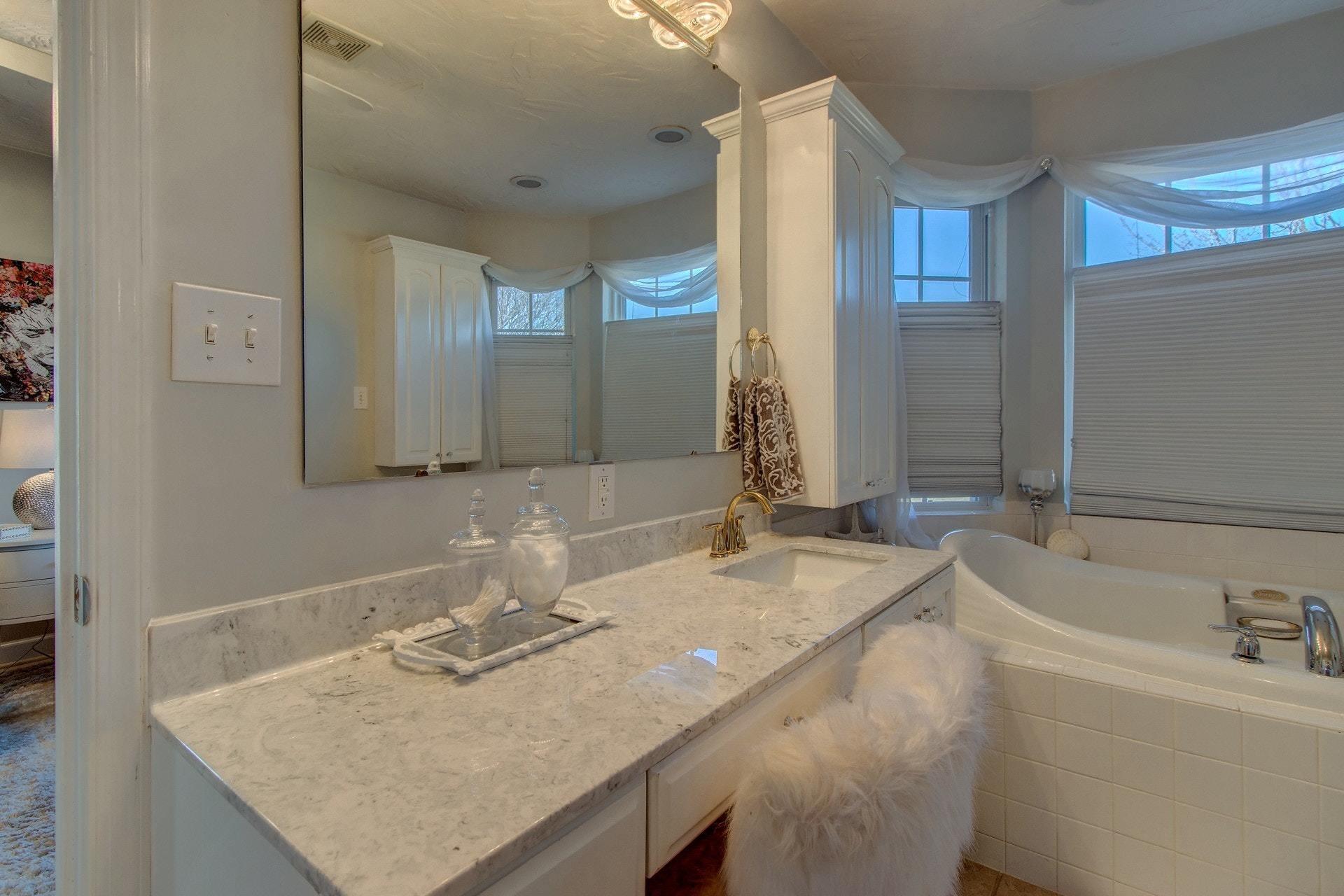 600 Dugwell Road Boones Mill, VA 24065 - Photo 44 of 78 a bathroom with a granite countertop sink and a bathtub
