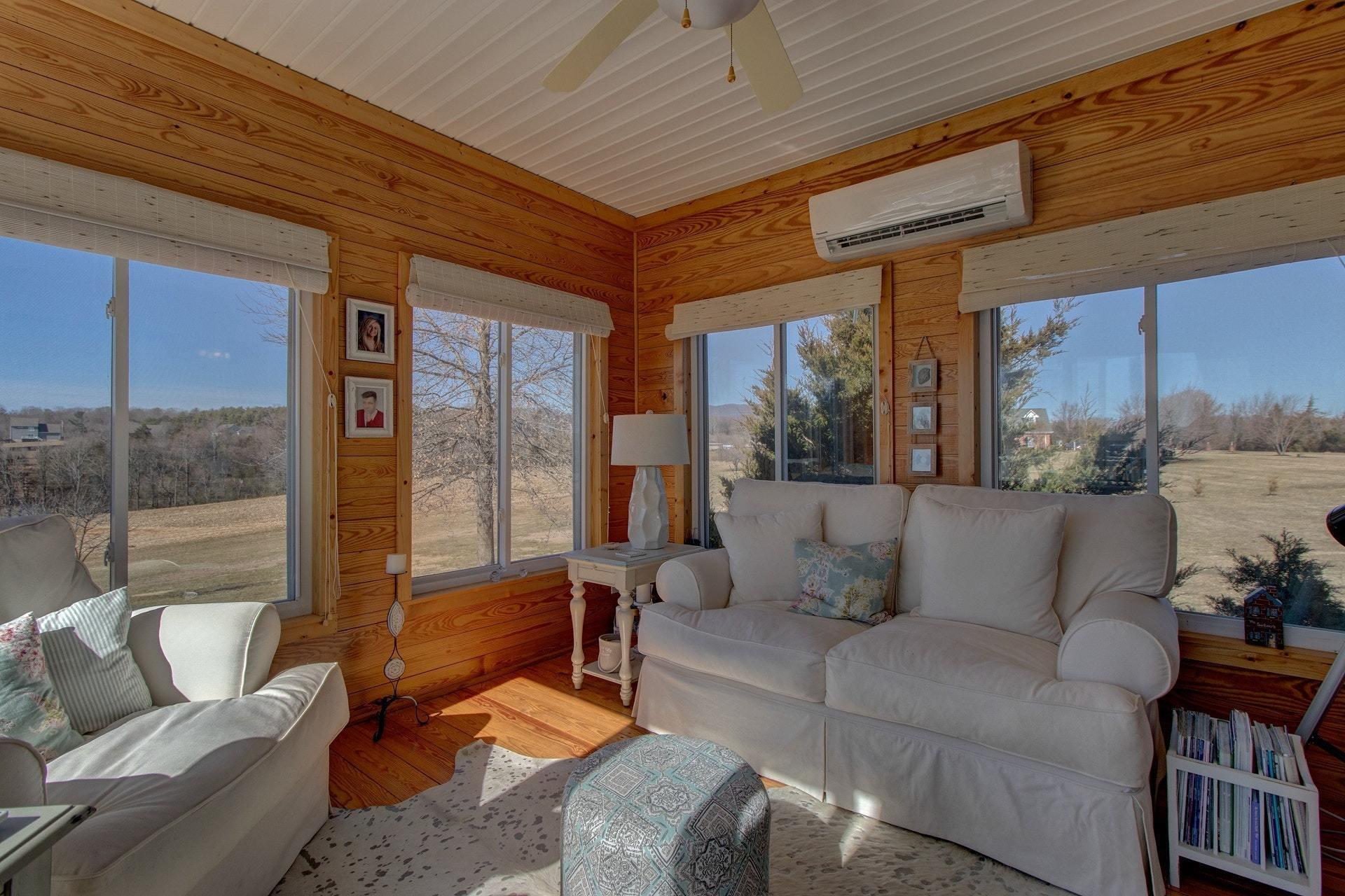 600 Dugwell Road Boones Mill, VA 24065 - Photo 47 of 78 a living room with furniture and a floor to ceiling window