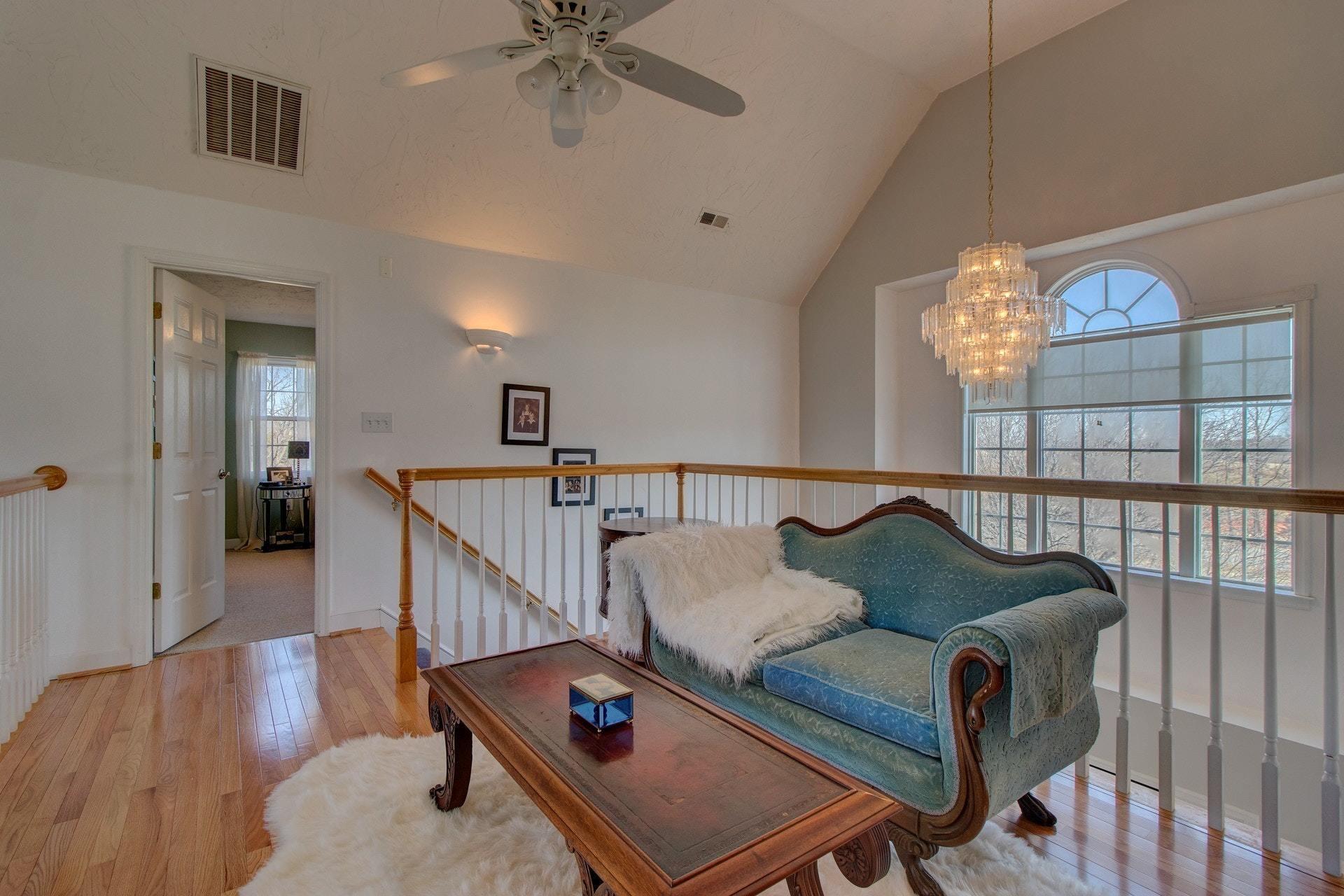 600 Dugwell Road Boones Mill, VA 24065 - Photo 49 of 78 a living room with furniture and a chandelier