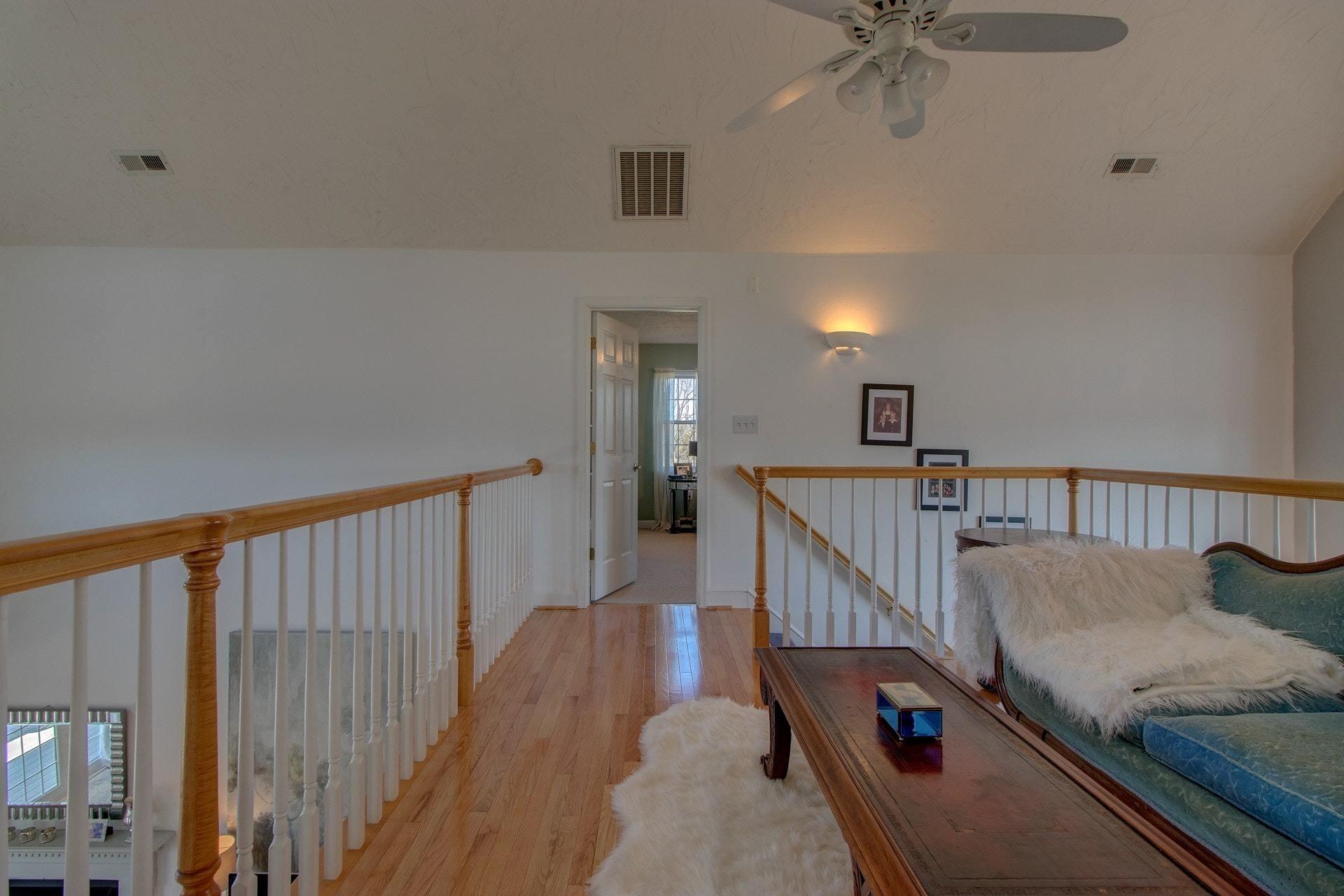 600 Dugwell Road Boones Mill, VA 24065 - Photo 50 of 78 a view of a hallway with couches and a chandelier