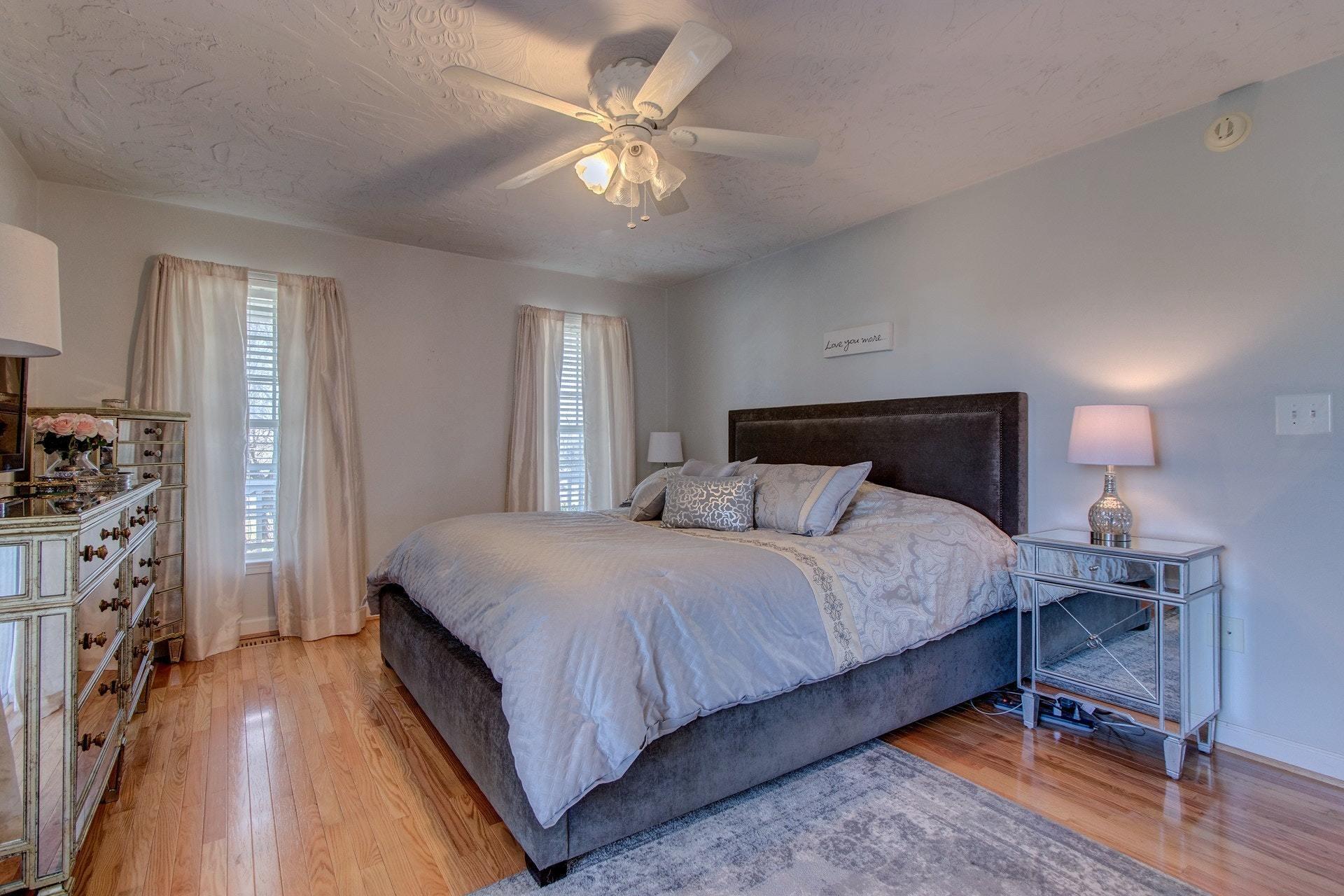 600 Dugwell Road Boones Mill, VA 24065 - Photo 7 of 78 a bedroom with a bed and a chandelier