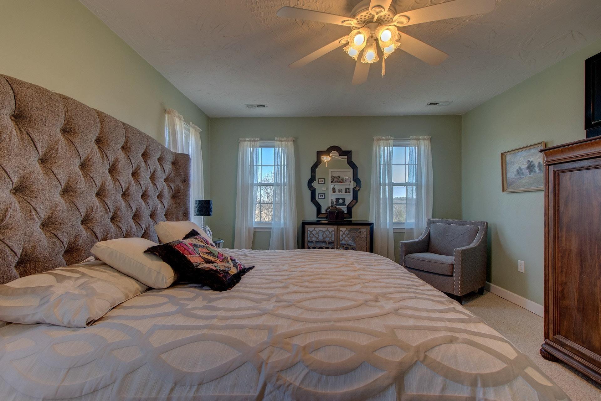 600 Dugwell Road Boones Mill, VA 24065 - Photo 58 of 78 a bedroom with a bed and a chandelier