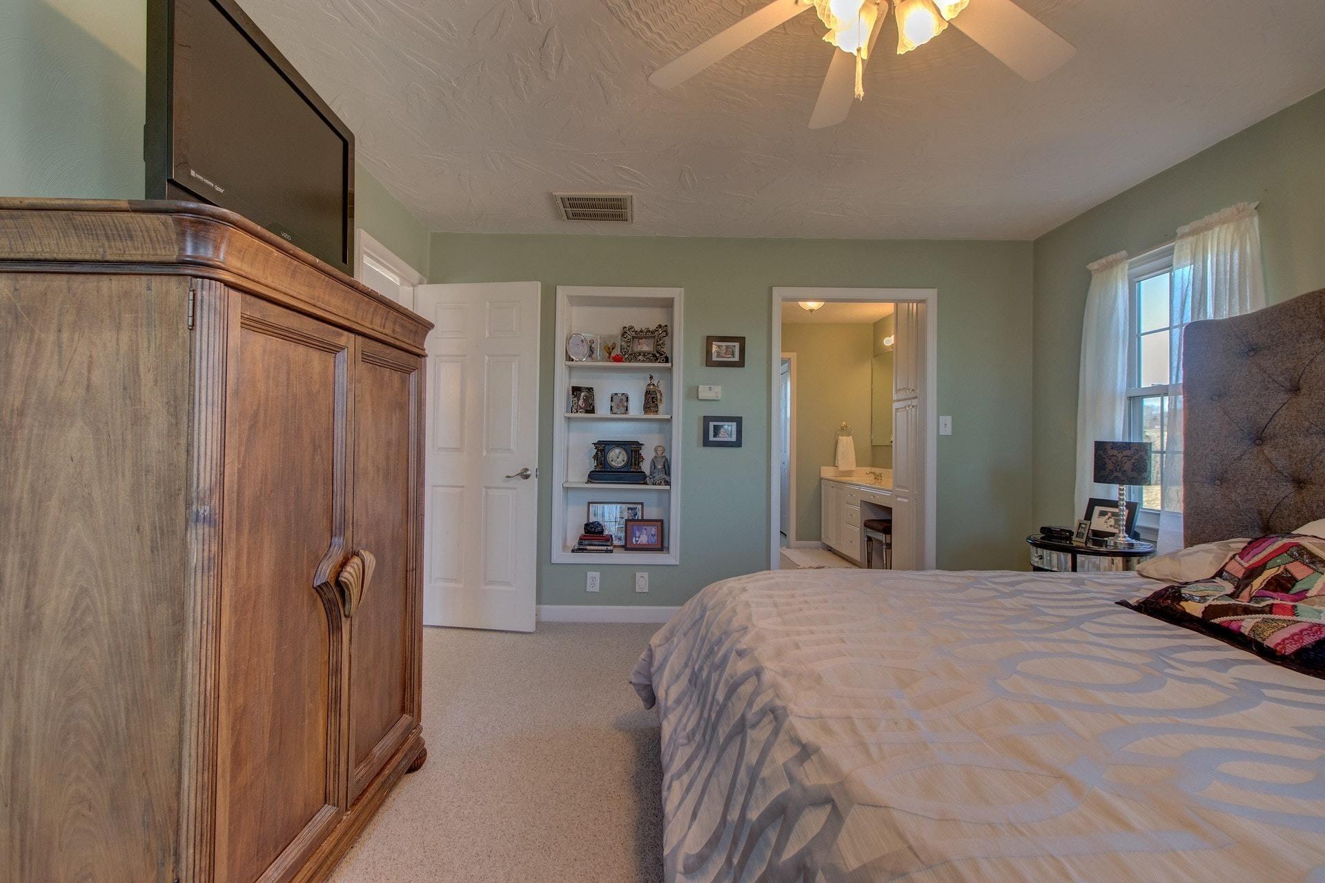600 Dugwell Road Boones Mill, VA 24065 - Photo 59 of 78 a bedroom with a bed and a flat tv screen on dresser