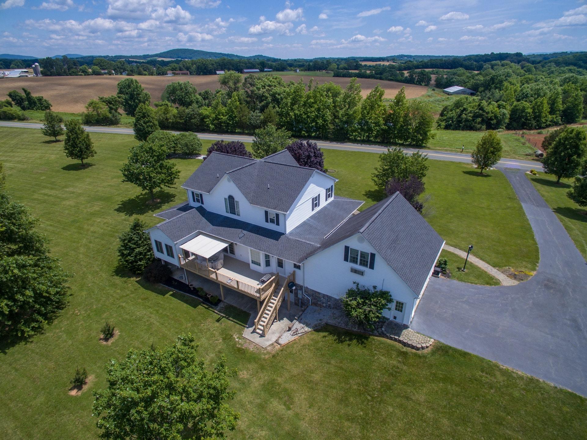 600 Dugwell Road Boones Mill, VA 24065 - Photo 64 of 78 an aerial view of a house with a garden and lake view