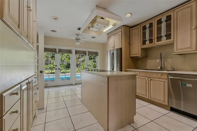 a kitchen with cabinets and wooden floor