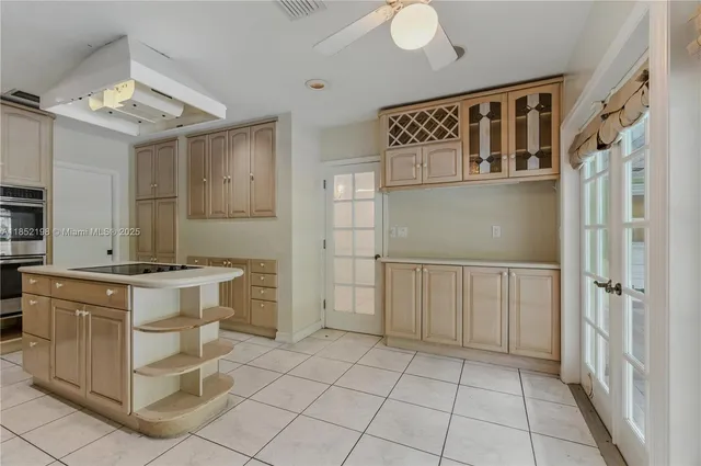 a kitchen with cabinets and stainless steel appliances