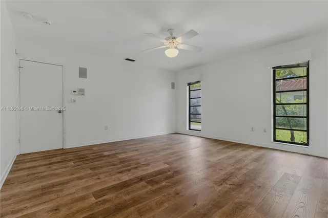 a spacious bedroom with a bed and a chandelier
