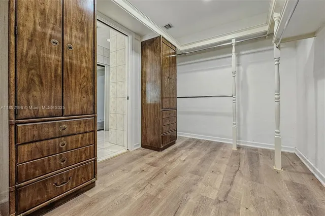 a bathroom with a glass shower door and a sink