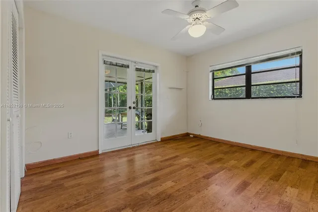 a view of a room with wooden floor and fence