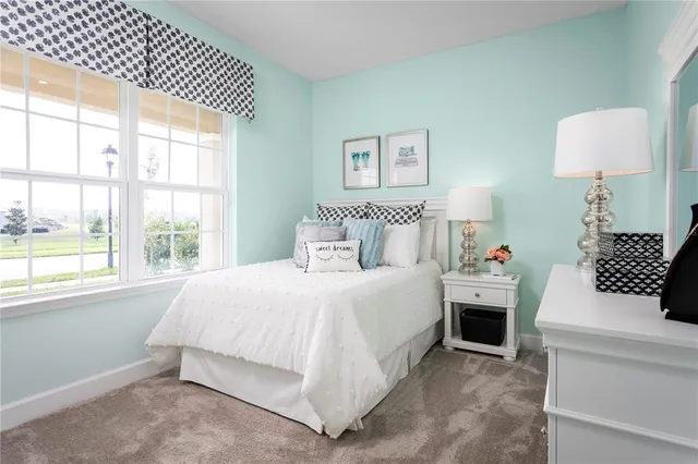 a bedroom with a bed and a lamp on table