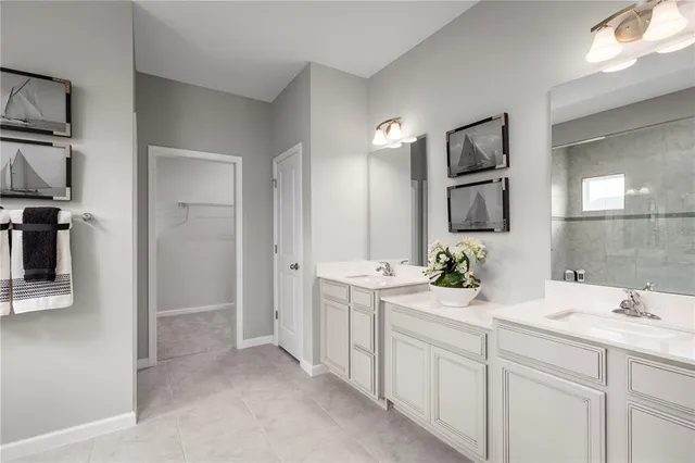 a bathroom with a double vanity sink and mirror