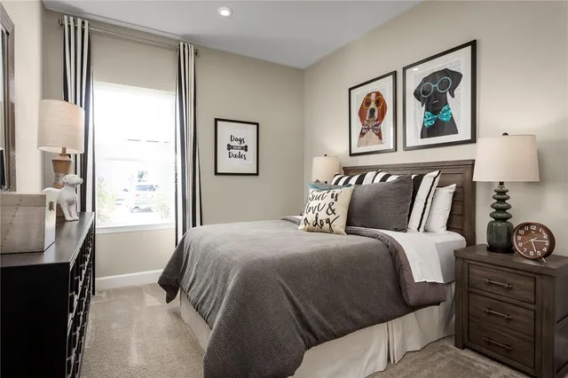 a bedroom with a bed and a painting on the wall