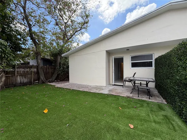 a house view with a sitting space and garden