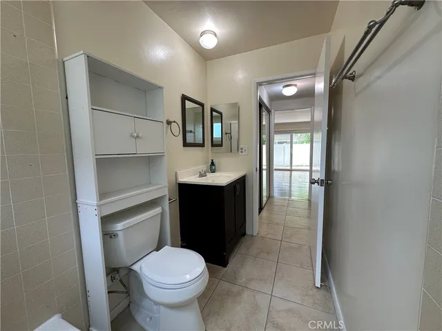 a bathroom with a sink toilet and mirror