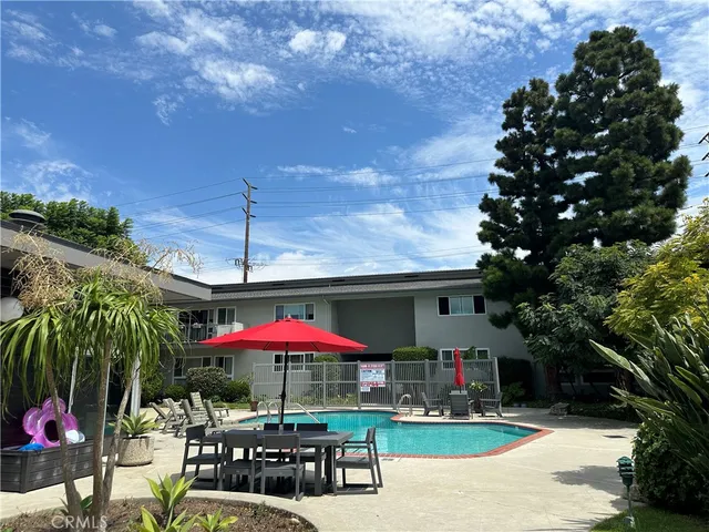 a patio with a table and chairs under an umbrella