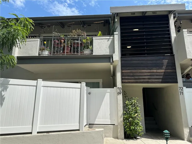 a front view of a house with plants