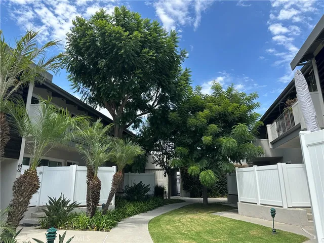 a view of backyard with a barn and large trees