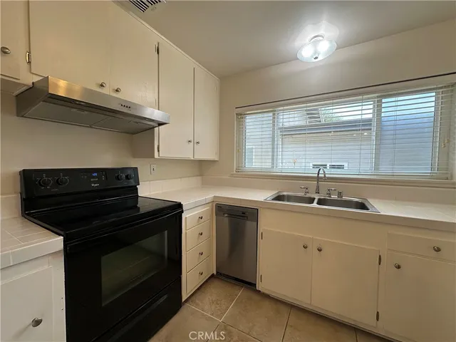 a kitchen with stainless steel appliances a stove sink and cabinets